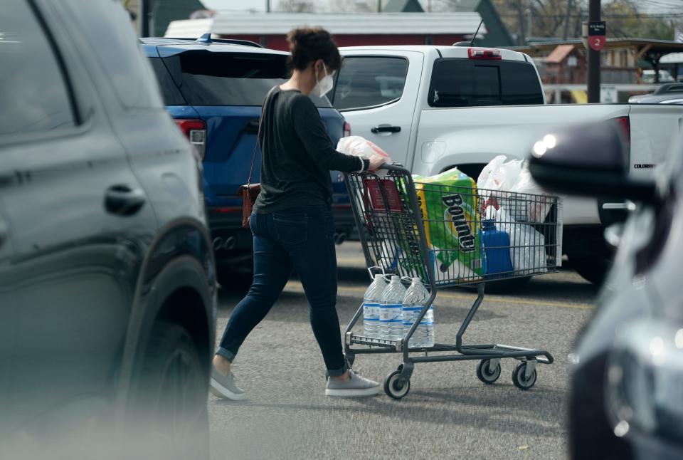 Shoppers buy water ahead of winter weather, Wednesday, Jan. 19, 2022. The cold front is likely to bring freezing rain and freezing temperatures to much of the region beginning Thursday night, making dangerous road conditions and power outages a possibility, according to the National Weather Service.