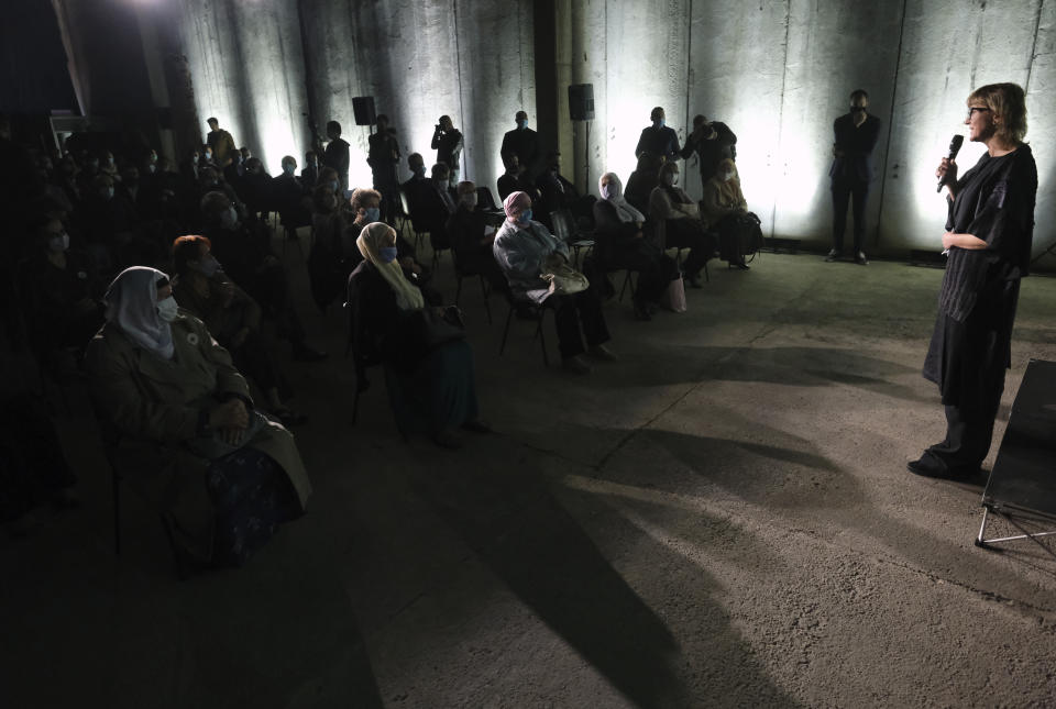 Bosnian filmmaker Jasmila Zbanic, right, speaks after the first public showing of the film on the 1995 massacre in Srebrenica - "Quo Vadis, Aida?", in the eastern Bosnian town of Srebrenica, Saturday, Oct. 10, 2020. The Srebrenica massacre was the culmination of Bosnia's 1992-95 war, which pitted the country's three main ethnic factions - Serbs, Croats and Bosnian Muslims. (AP Photo/Kemal Softic)