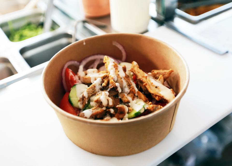 A rice bowl with chicken and vegetables, topped with a signature sauce, at Grilla Greek Kouzina on Broadway in Taunton on Friday, June 10, 2022. 