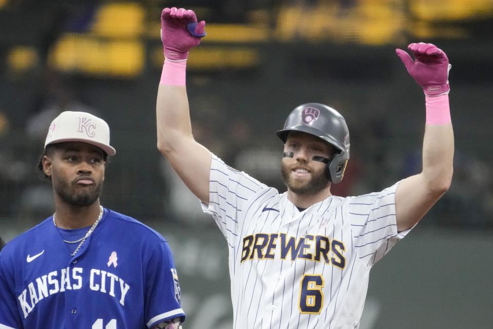 Milwaukee Brewers' Owen Miller reacts in front of Kansas City Royals' Maikel Garcia after hitting an RBI double during the third inning of a baseball game Sunday, May 14, 2023, in Milwaukee. (AP Photo/Morry Gash)