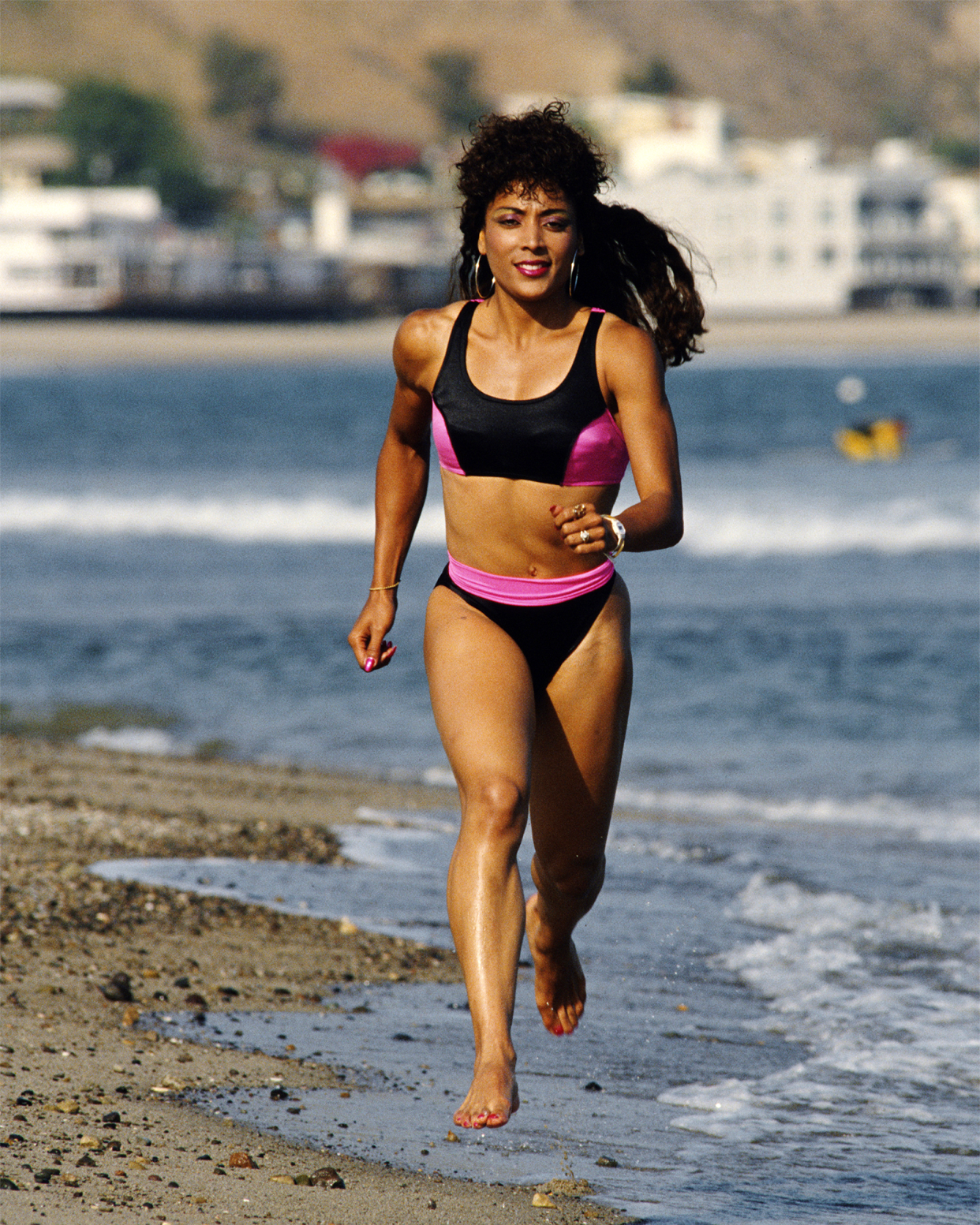 World and Olympic athletics champion Florence Griffith-Joyner of the United States (1959 - 1998) runs along the Pacific coast beach at Malibu