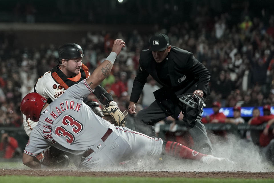 Cincinnati Reds' Christian Encarnacion-Strand (33) is tagged out at home plate by San Francisco Giants catcher Patrick Bailey, rear left, during the seventh inning of a baseball game, Monday, Aug. 28, 2023, in San Francisco. (AP Photo/Godofredo A. Vásquez)