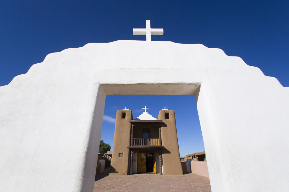 <p>Taos Pueblo is a tribute to the Pueblo people of what is now New Mexico and Arizona. Established in the late-13th and early-14th centuries, the Church in the Pueblo de Taos, shown here, is just part of the settlements in the area. The Pueblo culture is still active, and Taos is also known for its artistic community as well as the northern New Mexican cuisine (think fresh red and green chile). World Heritage site since 1992. (Photo: Richard Maschmeyer/Robert Harding/Getty Images) </p>