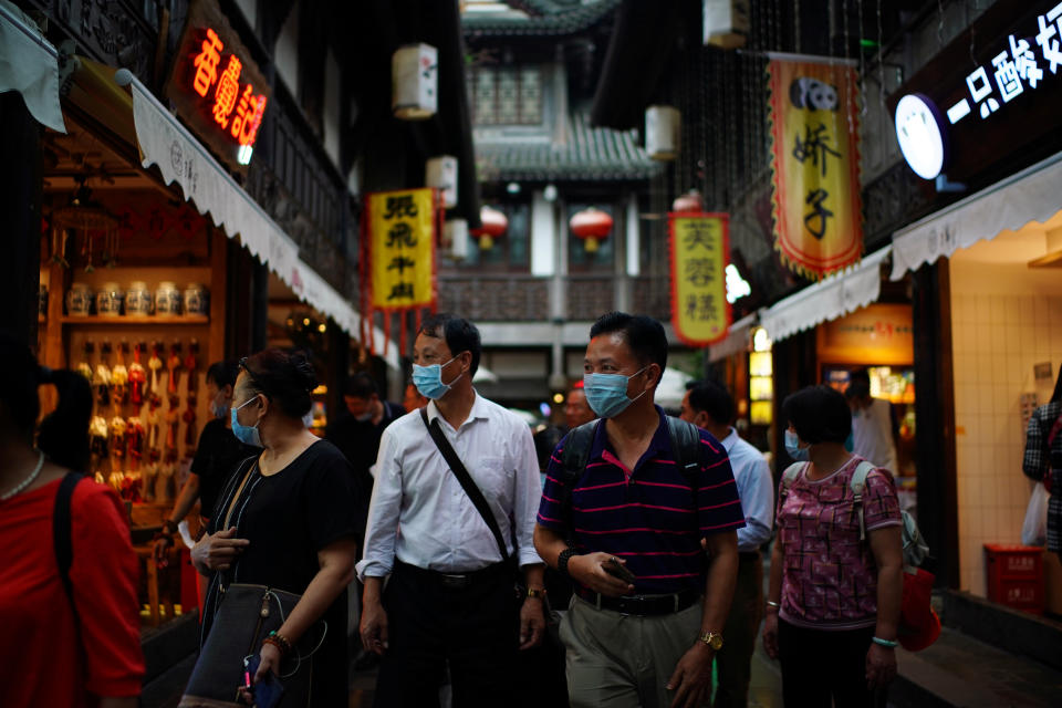 People wearing face masks walk on Jinli Ancient Street, following the coronavirus disease (COVID-19) outbreak, in Chengdu, Sichuan province, China September 8, 2020. REUTERS/Tingshu Wang