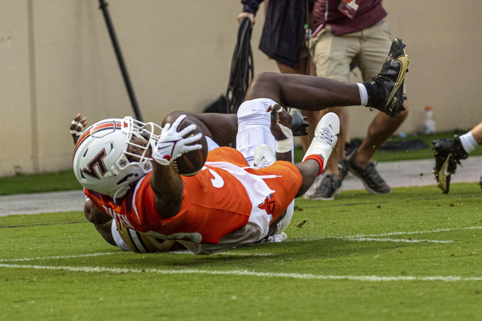 Virginia Tech's Bhayshul Tuten (33) runs in for a touchdown against Purdue during an NCAA college football Saturday, Sept. 9 2023, in Blacksburg, Va. (AP Photo/Robert Simmons)