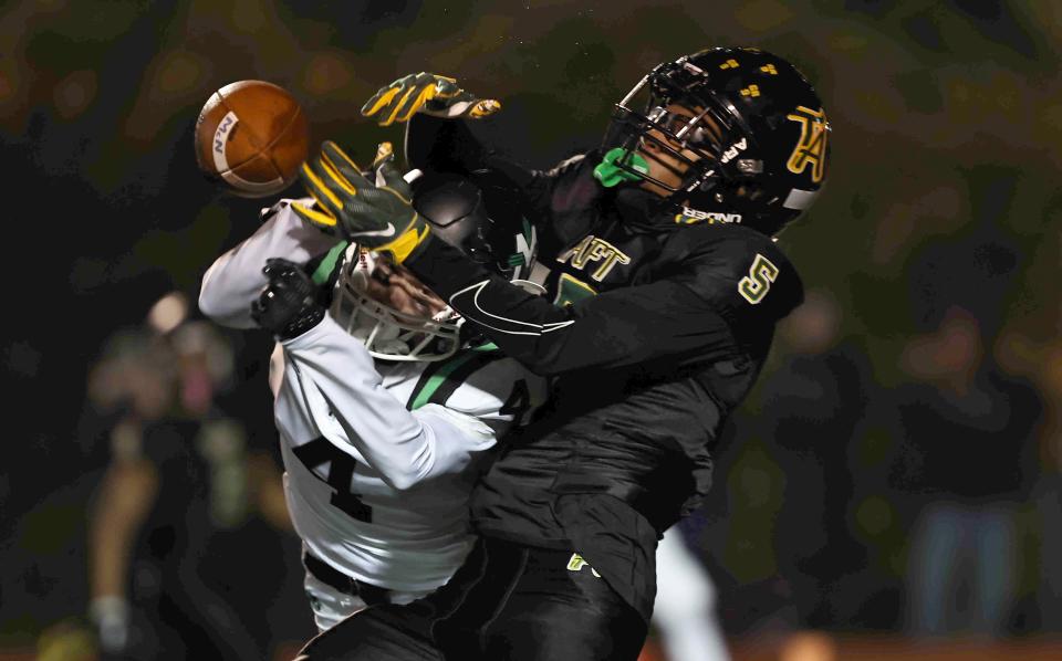 Taft defensive back Jay'Quan Bostic (5) breaks up a pass intended for McNicholas wide receiver Tyler Haynes during a playoff game between Taft and McNicholas high schools Nov 12.