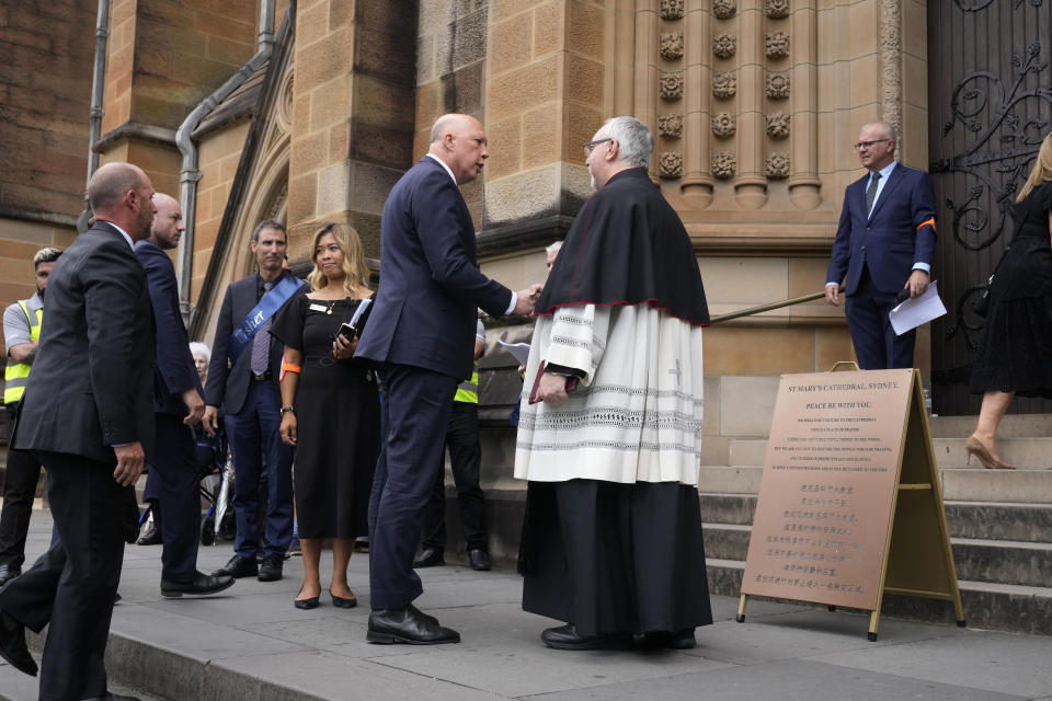 Leader of the federal opposition, Peter Dutton, center right, arrives at St. Mary's Cathedral before the funeral and interment of polarizing Cardinal George Pell in Sydney, Thursday, Feb. 2, 2023. Pell, who died last month at age 81, spent more than a year in prison before his sex abuse convictions were overturned in 2020. (AP Photo/Rick Rycroft)