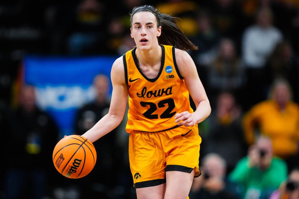 Iowa guard Caitlin Clark (22) dribbles down the court during the first round of the NCAA Tournament in Carver-Hawkeye Arena last March.