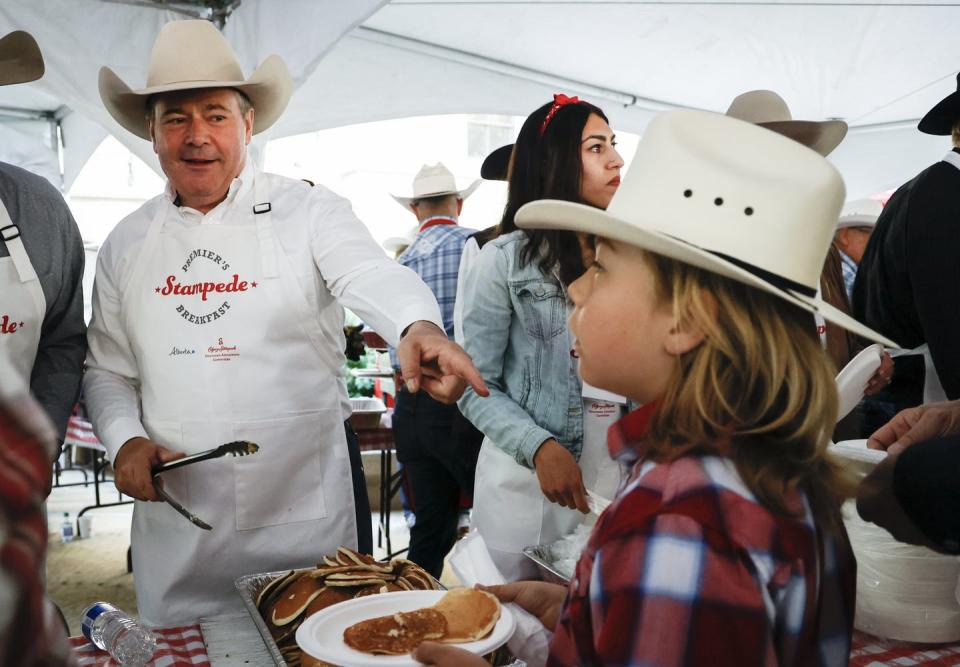 <span class="caption">Premier Jason Kenney serves pancakes at his last Stampede breakfast in Calgary on July 11. Kenney’s resignation set the stage for a United Conservative Party leadership race and several contenders are already discussing Alberta sovereignty.</span> <span class="attribution"><span class="source">THE CANADIAN PRESS/Jeff McIntosh</span></span>