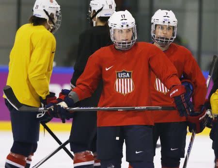 USA forwards Jocelyne Lamoureux (17) and Monique Lamoureux (7) look on during a women's ice hockey team practice at the 2014 Sochi Winter Olympics February 19, 2014. REUTERS/Lucy Nicholson