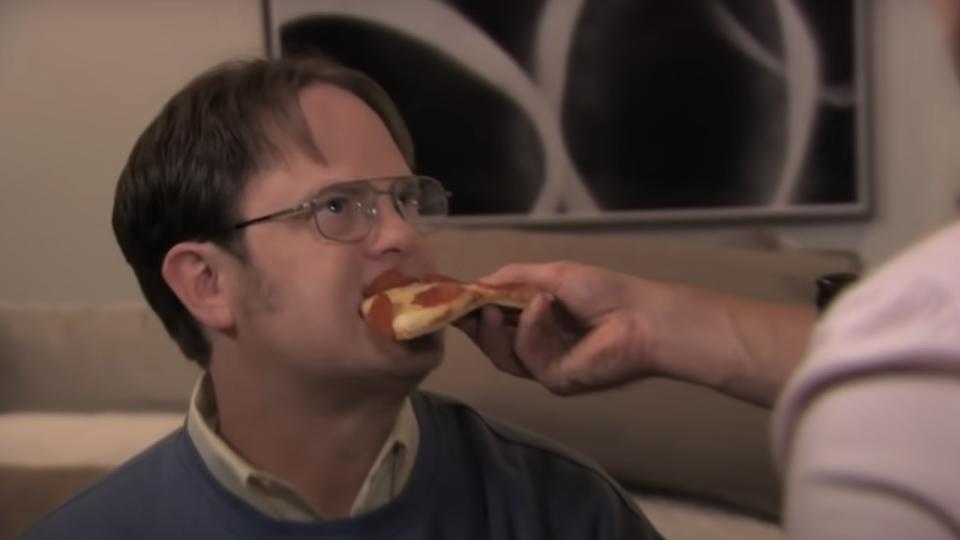 Dwight being fed pizza in The Office