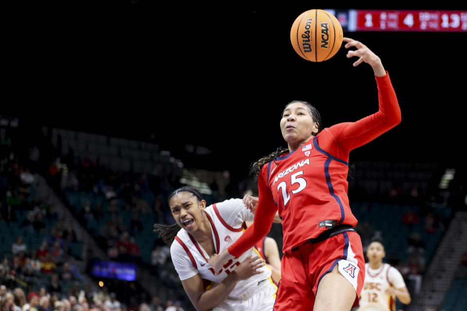 Arizona forward Breya Cunningham (25) rebounds a ball over Southern California center Rayah Marshall, left, during the second half of an NCAA college basketball game in the quarterfinal round of the Pac-12 tournament Thursday, March 7, 2024, in Las Vegas. (AP Photo/Ian Maule)