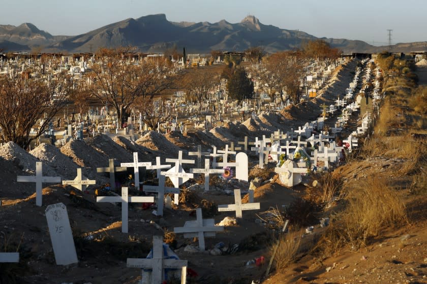 Juarez, Mexico-Dec. 4, 2020-Perches Funeral Homes ships bodies both ways across the U.S.-Mexico border, at least one a day heading south to Juarez, where funeral costs are cheaper. Covid dead are buried at both public and private cemeteries. The public Panteon San Rafael on the city's southern outskirts already has 820 Covid graves, three neat rows of white wooden crosses dating back to October, each bearing the funeral home name on the back, including Perches.The Covid-19 pandemic has been devastating on the metro area of El Paso, Texas and neighboring Juarez, El Paso. (Carolyn Cole / Los Angeles Times)