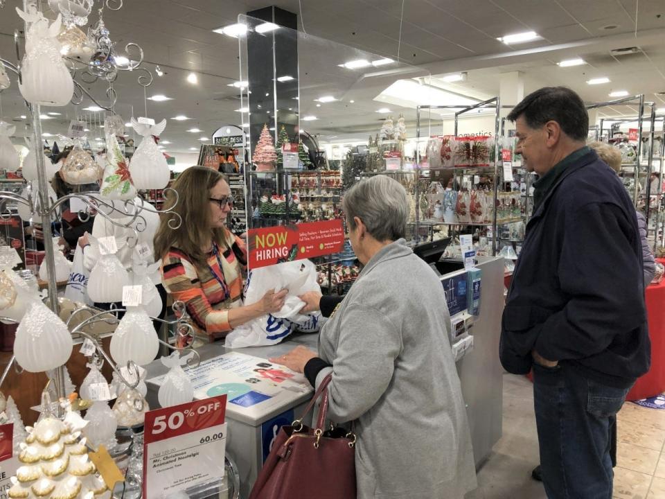Boscov's Sale Associate Maureen Berndlmaier assists customers John and Deborah Chagin of Philadelphia with a purchase in the busy giftware department on Black Friday.