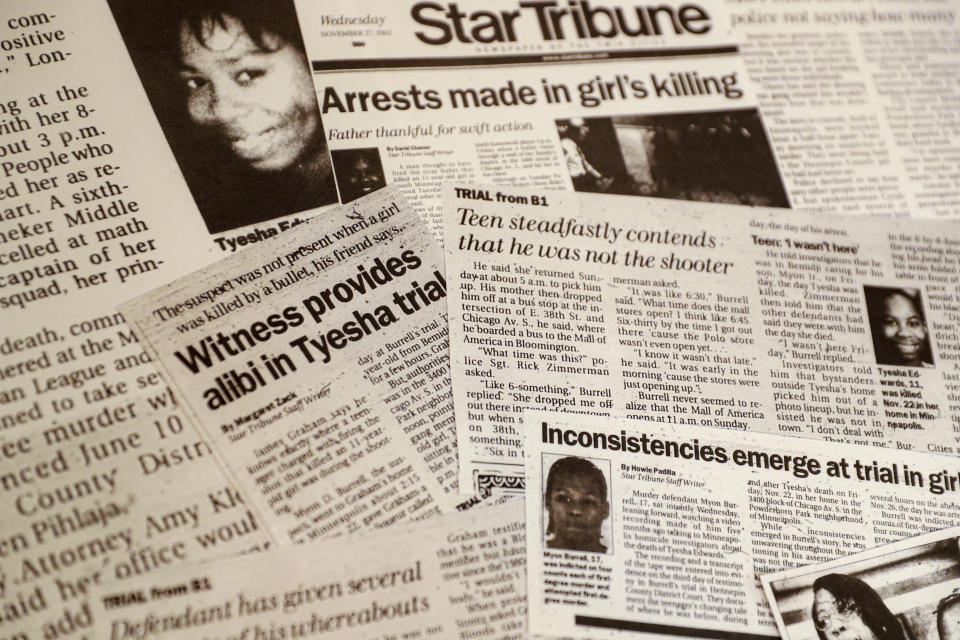 FILE - This Oct. 24, 2019 file photo shows a collection of newspaper clippings on the murder trail against Myon Burrell in Minneapolis. Burrell was 16 in 2002 when he was accused of firing a gun that killed 11-year-old Tyesha Edwards as she sat at her dining room table doing homework. Surveillance tapes were never reviewed to check Burrell’s story, and friends with him that day were not interviewed. No DNA, fingerprints, or weapon was found in the case. Most of the jailhouse snitches used to convict Burrell have since recanted, and police are shown on a video offering a man $500 for every name he provides -- even if it’s hearsay. Burrell was sentenced to life. (AP Photo/John Minchillo)