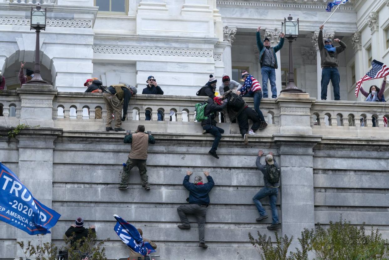 Supporters of President Donald Trump climb the west wall of the U.S. Capitol on Jan. 6, 2021. <a href="https://newsroom.ap.org/detail/ElectoralCollegeProtests/7143302aa07c4735add48358925717d9/photo?Query=Jan.%206%20rioters%20capitol&mediaType=photo&sortBy=&dateRange=Anytime&totalCount=730&digitizationType=Digitized&currentItemNo=13&vs=true&vs=true" rel="nofollow noopener" target="_blank" data-ylk="slk:AP Photo/Jose Luis Magana;elm:context_link;itc:0;sec:content-canvas" class="link ">AP Photo/Jose Luis Magana</a>