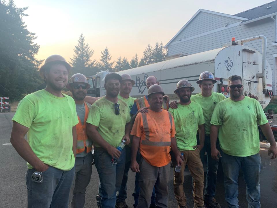 Some Emery & Sons Construction workers gather Wednesday evening after helping firefighters fight the Liberty Fire between Mildred Lane S and Jory Hill Road.