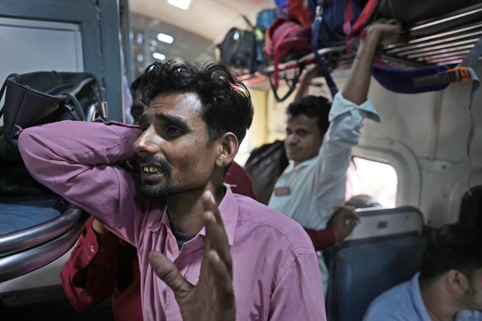 Rishipal Chaudhary, a locomotive driver, speaks as he travels in a general compartment of the Thirukkural Express Saturday, April 20, 2024. (AP Photo/Manish Swarup)