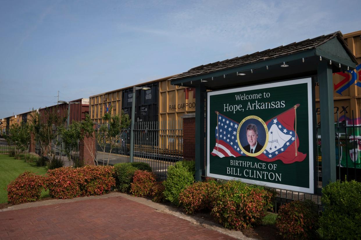 A train rolls past a welcome sign in downtown Hope, Arkansas.