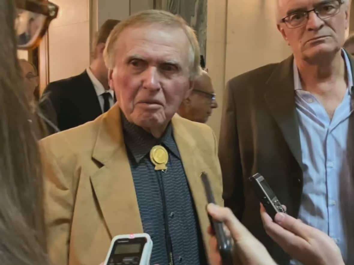 Colin Thatcher, former MLA of Saskatchewan and convicted murderer, speaks with media after the throne speech at the Saskatchewan Legislature in Regina, on Wednesday, October 26, 2022.  (CBC News - image credit)