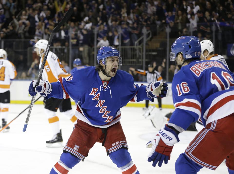 New York Rangers' Mats Zuccarello (36) and Derick Brassard (16) celebrate a goal by Benoit Pouliot during the second period in Game 7 of an NHL hockey first-round playoff series against the Philadelphia Flyers, Wednesday, April 30, 2014, in New York. (AP Photo)