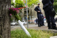 Flowers for victims are laid outside the Vladislav Ribnikar school in Belgrade, Serbia, Wednesday, May 3, 2023. Serbian police say a teenage boy opened fire at a school in central Belgrade, killing eight children and the school guard. (AP Photo/Darko Vojinovic)