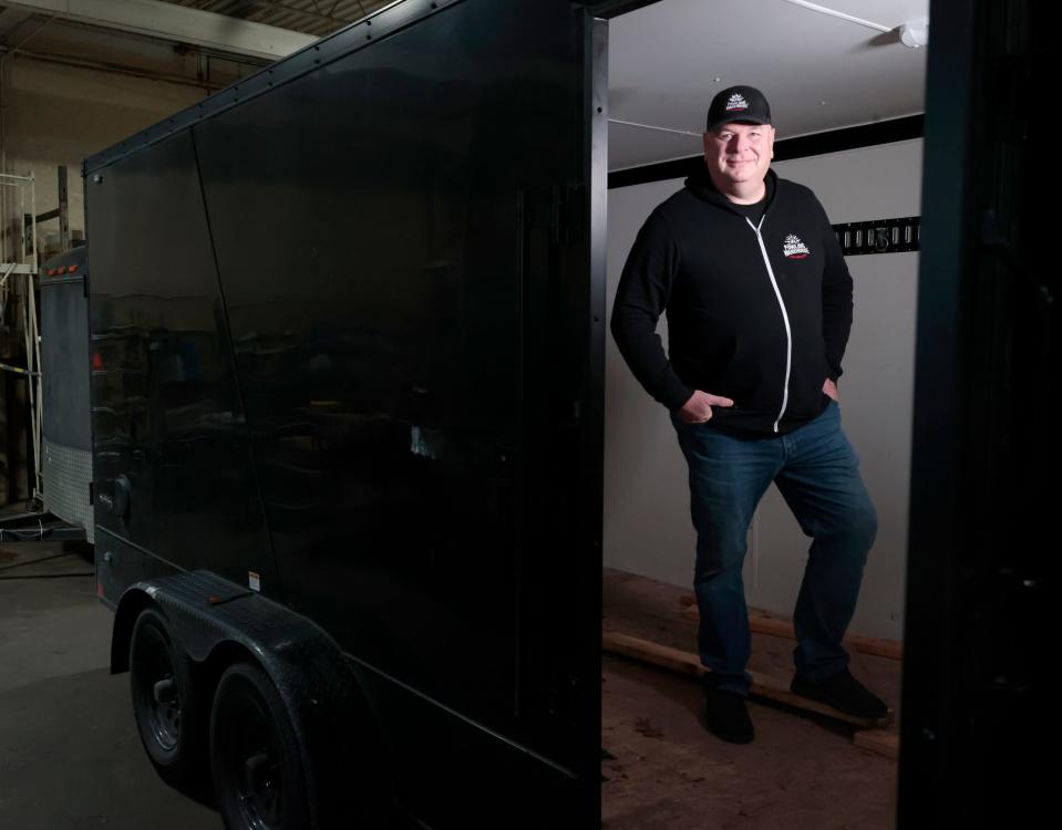 Scott Brown, 62, manager and co-owner of the Fowling Warehouse in Ypsilanti, with his recovered trailer currently parked inside the Fowling Warehouse in Hamtramck on Friday, Dec. 1, 2023. Brown’s trailer was stolen at 5:26 a.m. on Oct. 24, 2023, from his business in Ypsilanti and while the contents inside of bowling pins, wood gaming platforms and other items weren’t recovered, his $10,000 trailer was found intact.