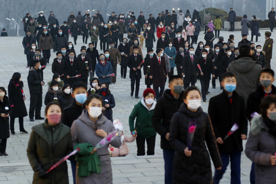 Citizens visit the bronze statues of their late leaders Kim Il Sung and Kim Jong Il on Mansu Hill in Pyongyang, North Korea Thursday, Dec. 16, 2021, on the occasion of 10th anniversary of demise of Kim Jong Il. (AP Photo/Cha Song Ho)