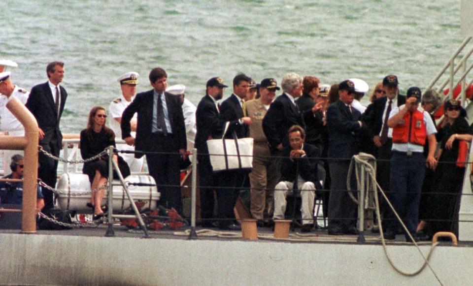 HYANNIS PORT, UNITED STATES:  Kennedy and Bessette family members stand on the Coast Guard boat Hammerhead on their return from a burial at sea for John F. Kennedy, Jr., Carolyn Bessette Kennedy and Lauren G. Bessette 22 July 1999 in Woods Hole, Massachusetts. The burial at sea on the US Navy ship, USS Briscoe, was off Martha's Vineyard.  AFP PHOTO/John MOTTERN (Photo credit should read JOHN MOTTERN/AFP via Getty Images)