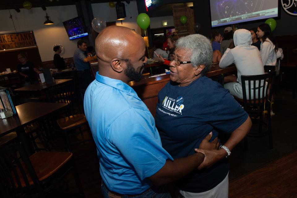 Marcus Miller listens to his grandmother, Iona Moore, after she congratulates him Tuesday on being elected to the District 6 seat of the Topeka City Council. Miller held a watch party at Henry T's.