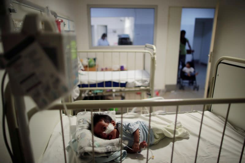 A child from the indigenous Wichi community lies in a bed while undergoing medical treatment, in a hospital in Tartagal