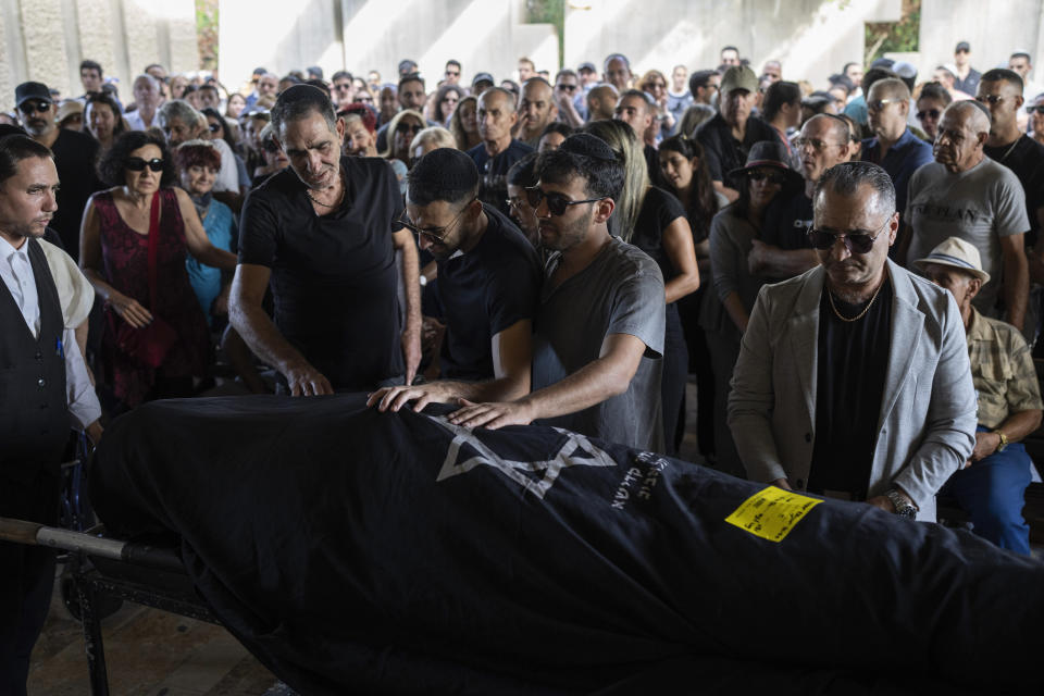 Mourners attend the funeral of the Israeli woman Celine Ben David -Nagar, killed by Hamas militants while attending a music festival at a cemetery in Holon, central Israel, Tuesday, Oct. 17, 2023. (AP Photo/Petros Giannakouris