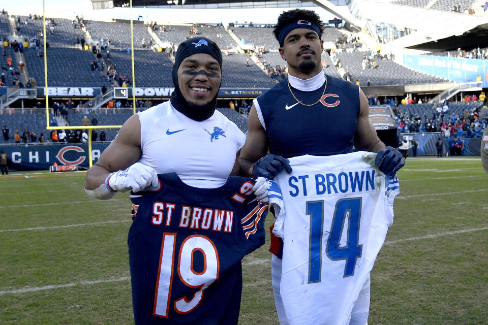 Amon-Ra St. Brown of the Detroit Lions (left) and Equanimeous St. Brown of the Chicago Bears pose with each other's jerseys after Detroit's 31-30 win at Soldier Field on Nov. 13. (Quinn Harris/Getty Images)