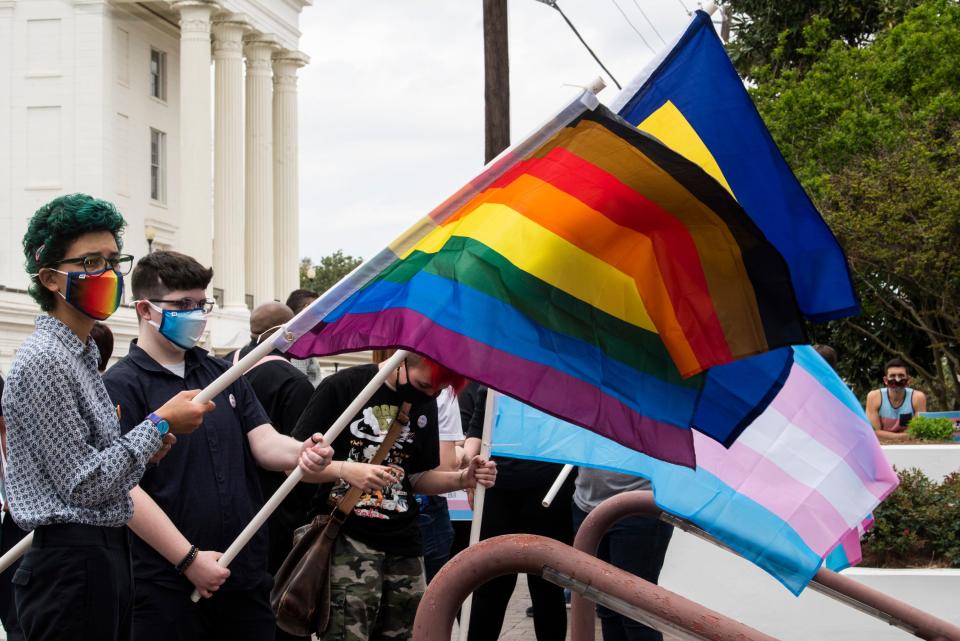 Protestors in support of transgender rights rally outside the Alabama State House in Montgomery, Ala., on Tuesday, March 30, 2021.