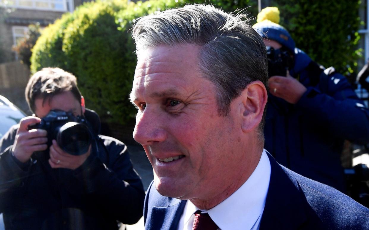 Sir Keir Starmer forces a grin as he leaves his London home this morning - Reuters