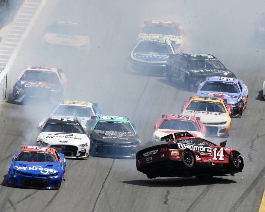 Chase Briscoe's car (No. 14) gets a bit airborne as a crash ignites through the front dog-leg Sunday at Daytona.