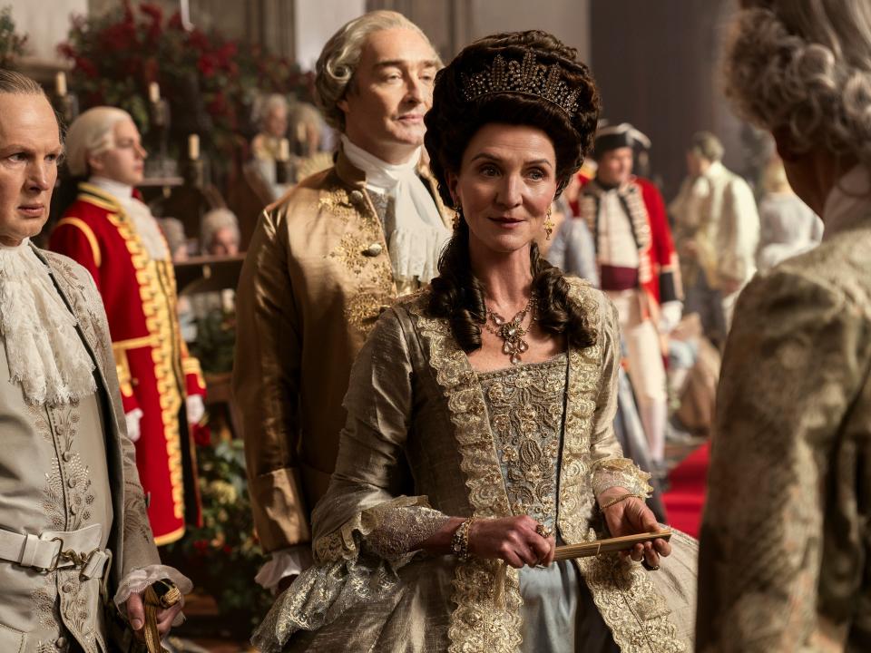 Richard Cunningham as Lord Bute, Neil Edmond as Earl Harcourt, and Michelle Fairley as Princess Augusta in episode one of "Queen Charlotte: A Bridgerton Story."