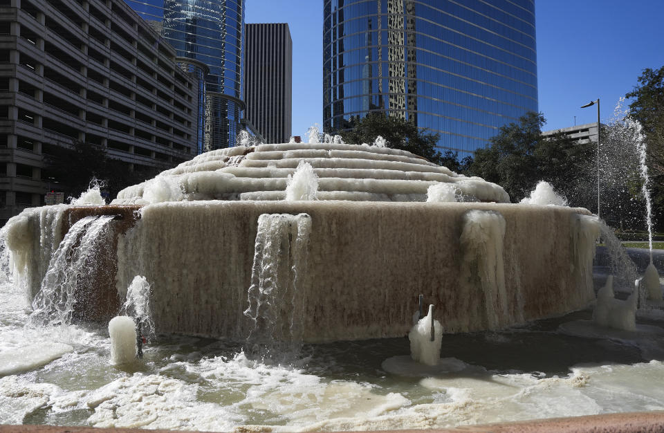 A fountain at Antioch Park in downtown Houston still runs as ice forms on it, Tuesday, Jan. 16, 2024. (Elizabeth Conley/Houston Chronicle via AP)