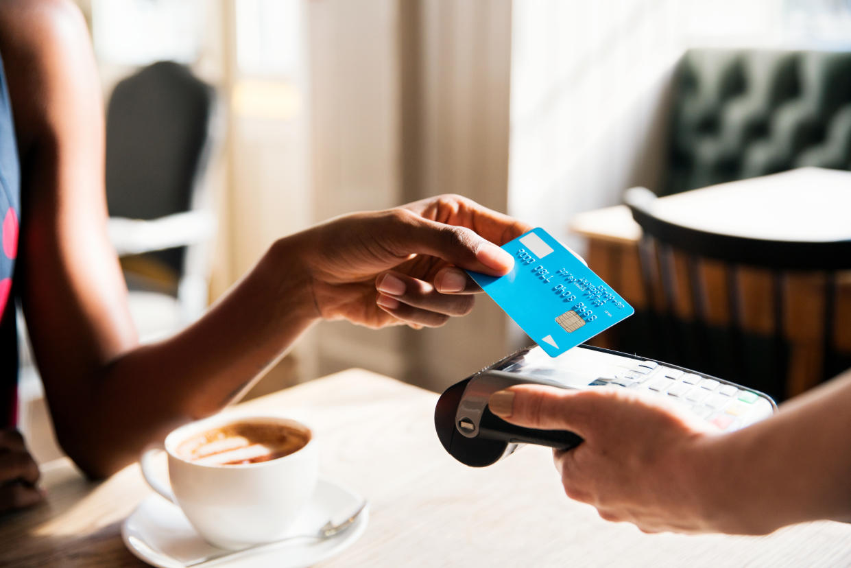 Woman paying with credit card in shop