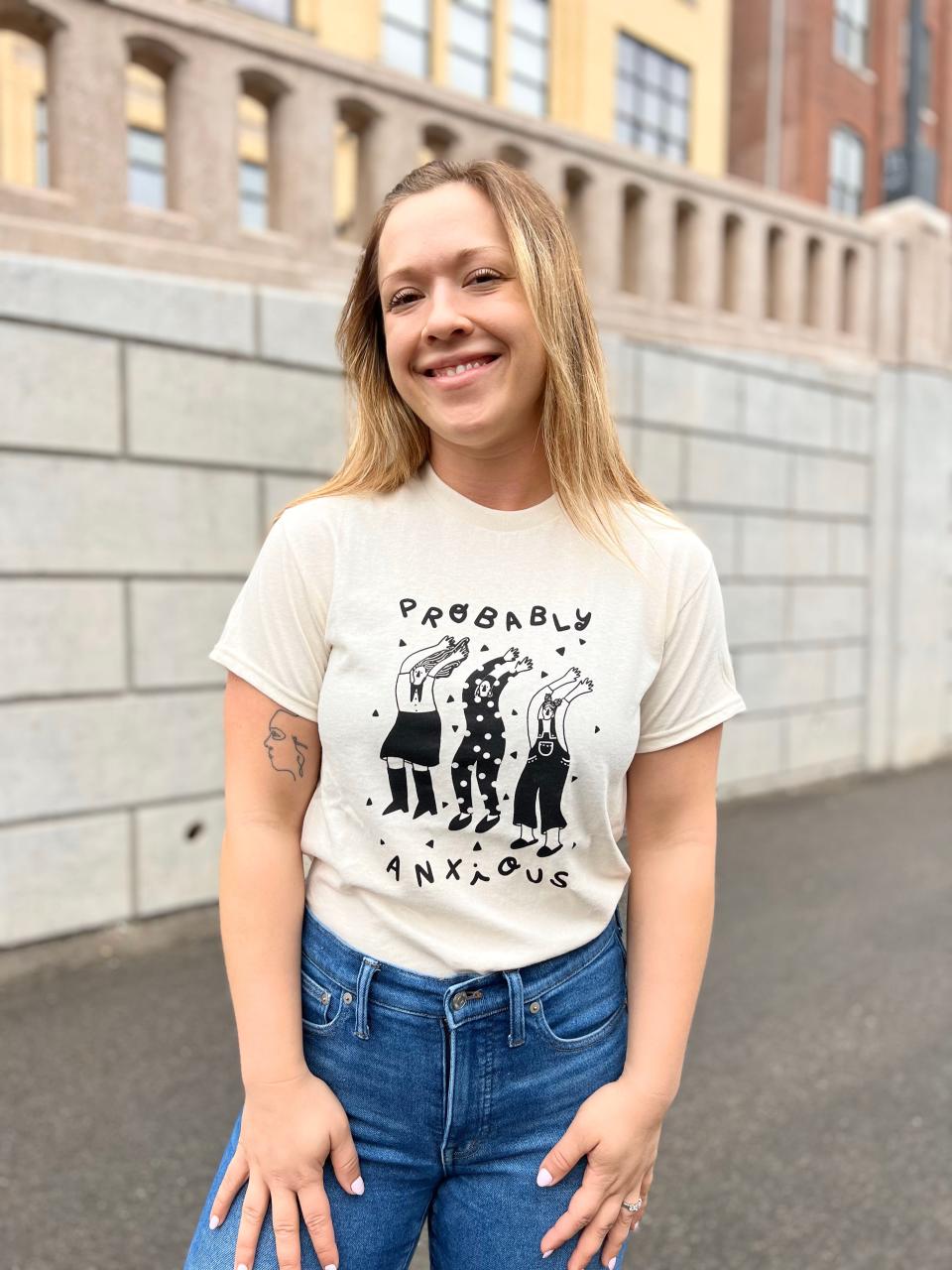 Paris Woodhull with her bestselling T-shirt in her print shop and artist’s studio on Sept. 2, 2022.