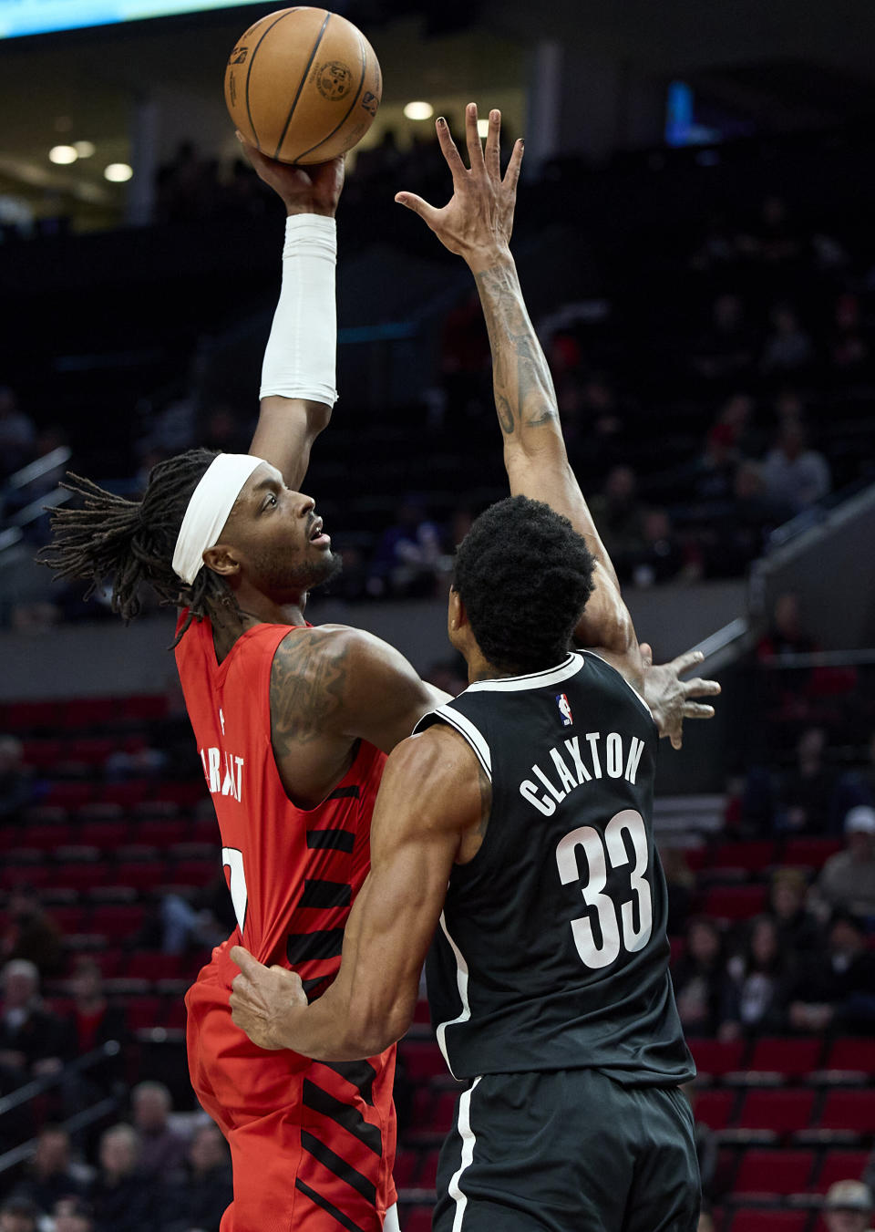 Portland Trail Blazers forward Jerami Grant, left, shoots over Brooklyn Nets center Nic Claxton during the first half of an NBA basketball game in Portland, Ore., Wednesday, Jan. 17, 2024. (AP Photo/Craig Mitchelldyer)