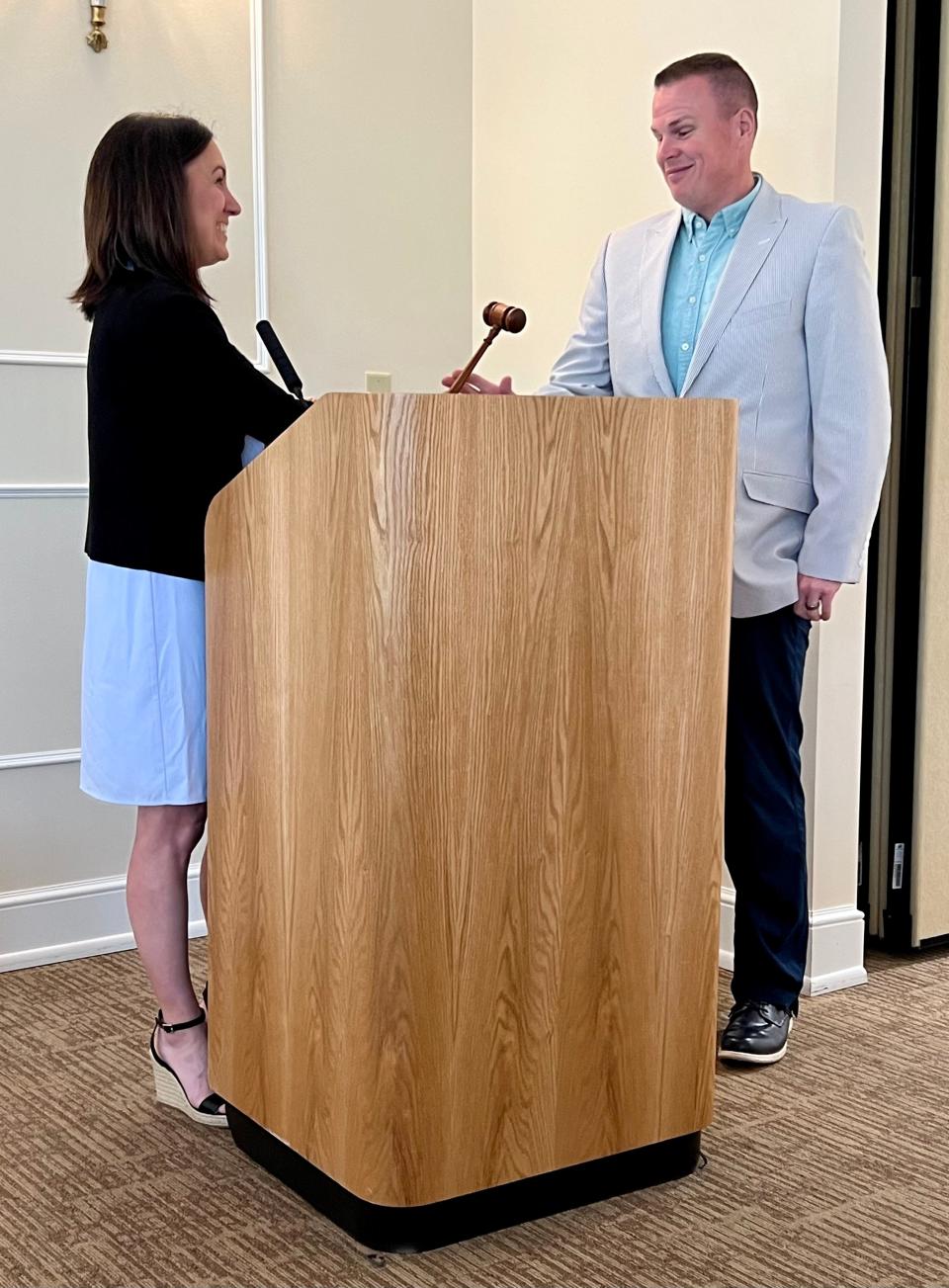 Board Chairwoman Jessica Gribben hands over the gavel to incoming Chairman Chris Hiner during the Richland County Foundation's annual meeting.