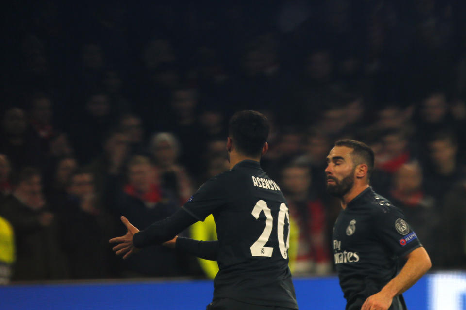 Real midfielder Marco Asensio, left, celebrates after scoring his side's second goal during the first leg, round of sixteen, Champions League soccer match between Ajax and Real Madrid at the Johan Cruyff ArenA in Amsterdam, Netherlands, Wednesday Feb. 13, 2019. (AP Photo/Peter Dejong)