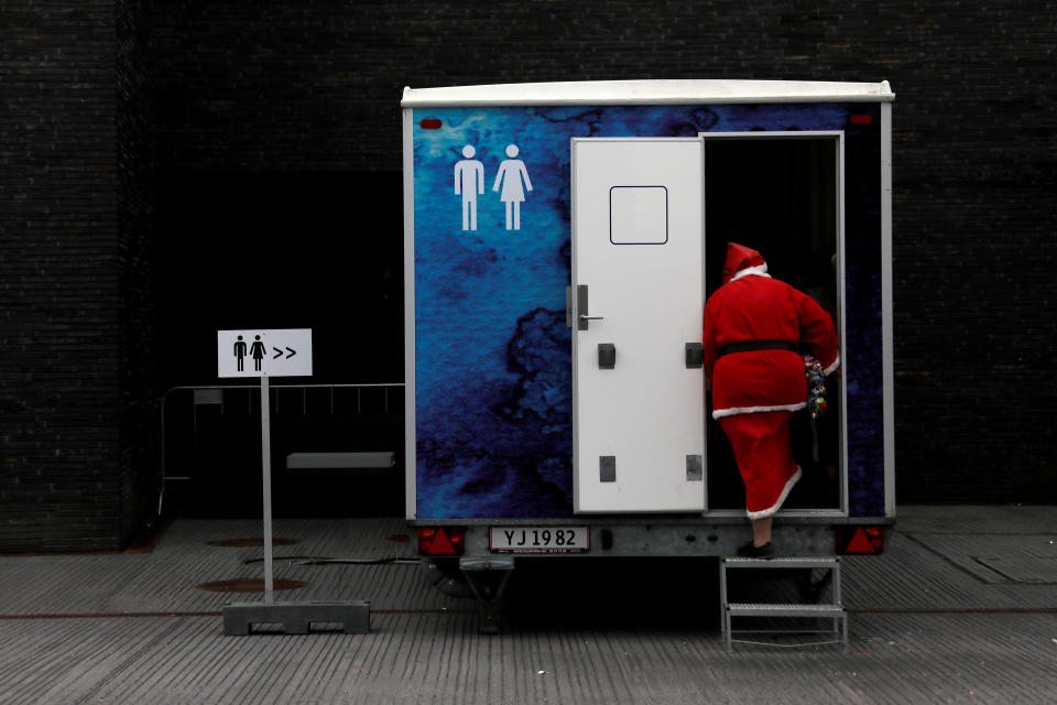 <p>A person dressed as Santa Claus uses a restroom during the World Santa Claus Congress, an annual event held every summer in Copenhagen, Denmark, July 23, 2018. (Photo: Andrew Kelly/Reuters) </p>