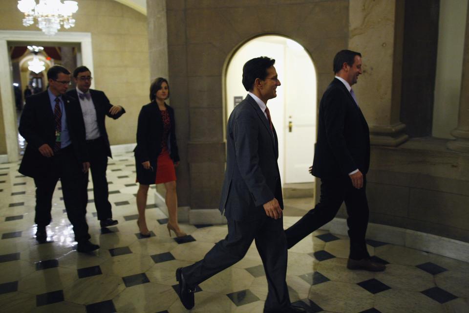 U.S. House Majority Leader Eric Cantor (R-VA) (C) walks into the offices of Speaker John Boehner (R-OH) (not pictured) during a rare late-night Saturday session at the U.S. Capitol in Washington, September 28, 2013. The U.S. government edged closer on Saturday to a shutdown as Republicans in the House of Representatives rejected an emergency spending bill approved by the Senate and pushed instead for a one-year delay of President Barack Obama's healthcare reform law. REUTERS/Jonathan Ernst