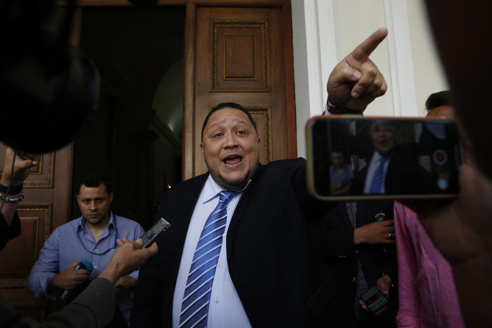 Lawmaker Jose Brito tells the press he supports fellow lawmaker Luis Parra as the legislature's president, after Parra's press conference at the National Assembly in Caracas, Venezuela, Monday, Jan. 6, 2020. The previous day, lawmakers loyal to President Nicolas Maduro rushed to choose Parra as their new legislative president, while many opposition lawmakers were blocked from entering the voting session. (AP Photo/Andrea Hernandez Briceño)