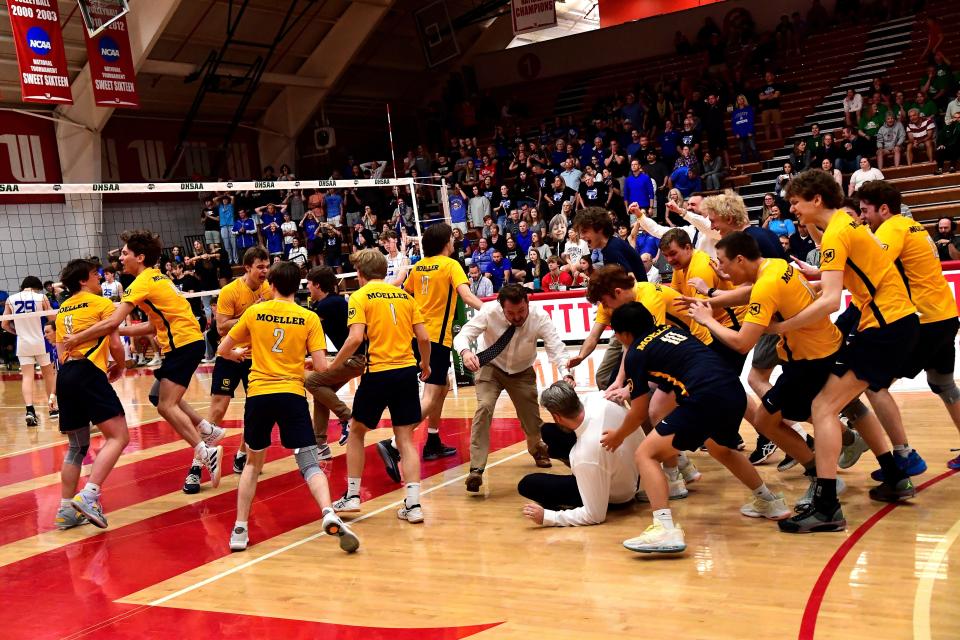 The Moeller Crusaders storm the court in jubilation after coming back from a 0-2 deficit to win the title 3-2 at the Inaugural OHSAA Division I Boys Volleyball State Championship, May 28, 2023.