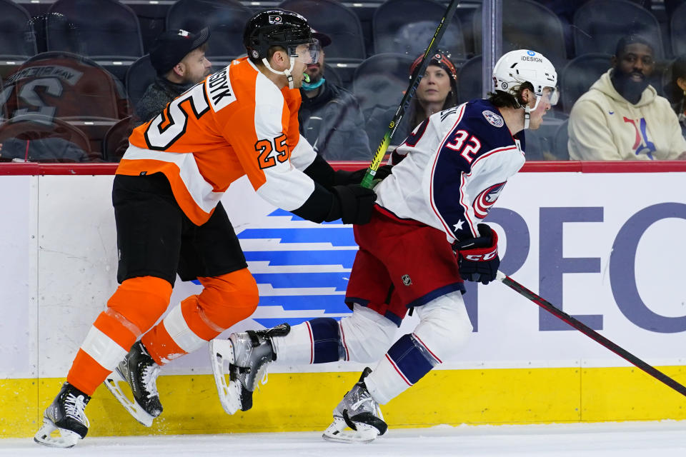 Philadelphia Flyers' James van Riemsdyk, left, shoves Columbus Blue Jackets' Jake Christiansen during the first period of an NHL hockey game, Thursday, Jan. 20, 2022, in Philadelphia. (AP Photo/Matt Slocum)