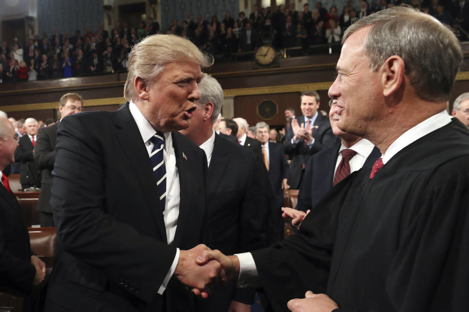 FILE - In this Feb. 28, 2017, file photo, President Donald Trump shakes hands with Supreme Court Chief Justice John Roberts as he arrives on Capitol Hill in Washington, for his address to a joint session of Congress. In Trump’s America, is anyone listening to the conservative wise men who damn him with faint, coded criticism? (Jim Lo Scalzo/Pool Image via AP, File)