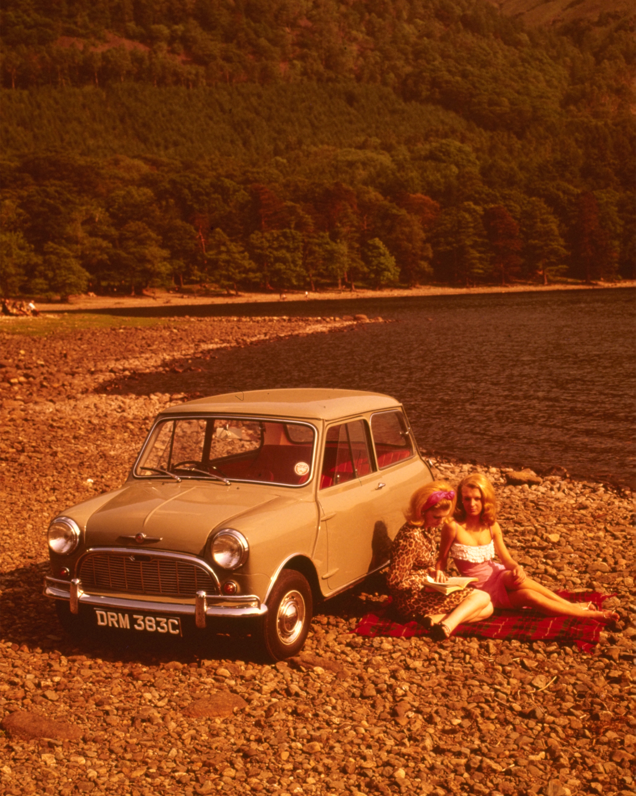 A Morris mini parked on a shingle beach